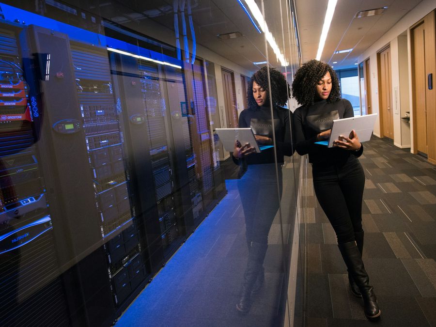 A data centre aisle with blue-lit server racks
