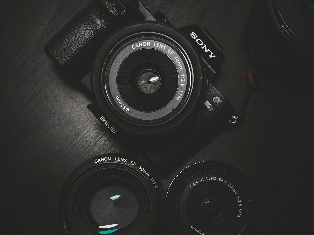 Camera body and lenses on a dark surface