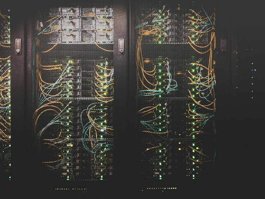 A network cabinet with a patch panel and blue cables